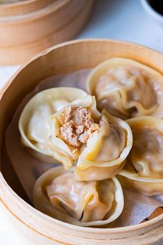 some dumplings are sitting in a wooden bowl