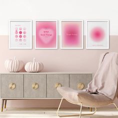 a pink room with three pictures on the wall and a chair in front of it