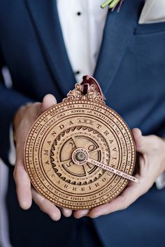 a man in a suit holding a wooden clock