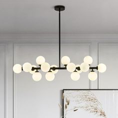 a modern style chandelier with white glass balls hanging from it's ceiling