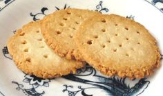 two crackers sitting on top of a blue and white plate next to each other