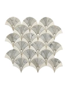 the back side of a white and grey wall with fan shaped tiles on it's sides