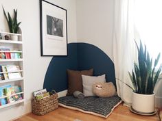 a room with bookshelves and plants in it