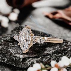 a diamond ring sitting on top of a rock