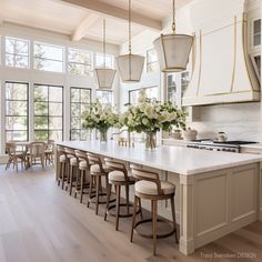 a large kitchen with an island and lots of counter space, along with chairs around it