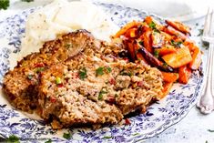 meatloaf, mashed potatoes and carrots on a blue and white plate