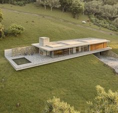 an aerial view of a house in the middle of a field