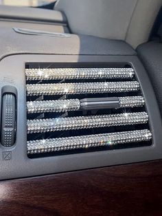 the interior of a car with many crystal beads on it's dash board and center console