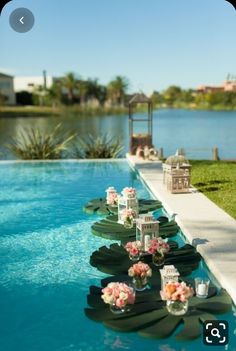 an empty pool with flowers and candles on the edge