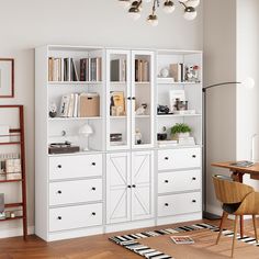 a white bookcase with lots of books on it