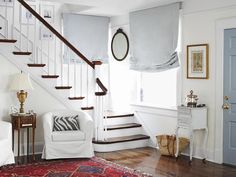 a living room filled with furniture and a stair case