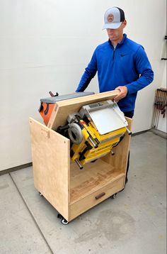 a man standing next to a wooden box with tools in it