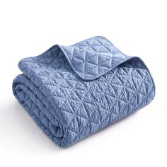 a blue quilted blanket folded on top of each other