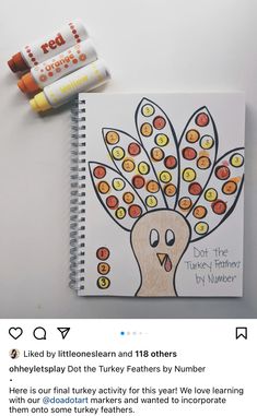 a notepad with an image of a turkey and two crayons next to it