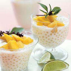 two glasses filled with fruit on top of a white plate