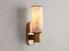 a wall light that is on the side of a wall with a marbled glass shade