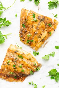 two pieces of chicken with parsley on top