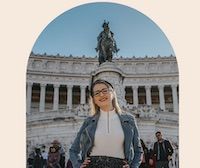 a woman standing in front of a building