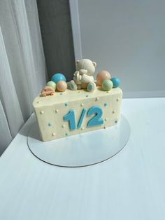 a birthday cake with the number twelve on it and teddy bears sitting at the top