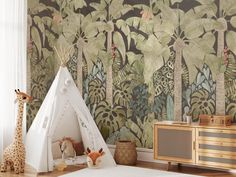 a child's room with a teepee tent and jungle wallpaper