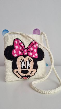 a minnie mouse purse with a pink bow on it