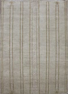 a beige and white rug with vertical stripes on the bottom, in an old fashion style