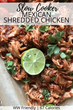 slow cooker mexican shredded chicken with lime and cilantro on the side in a serving dish