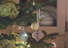 ornaments hanging from the top of a christmas tree