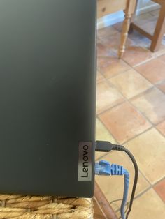 a laptop computer sitting on top of a wicker table