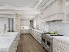 a large kitchen with marble counter tops and white cabinets