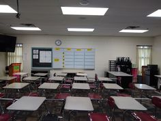 an empty classroom with desks and chairs