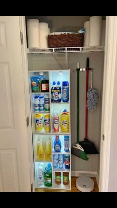 an organized pantry with cleaning supplies and toiletries in the door way, on top of a hard wood floor