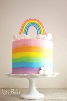 a rainbow cake with marshmallows on top and a rainbow shaped frosting