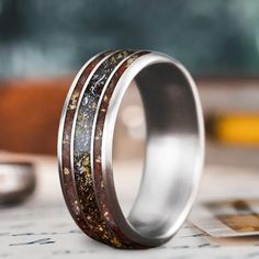 two wedding bands with different colored wood inlays are shown on top of each other