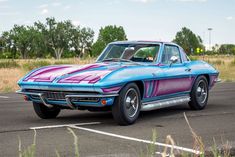 a blue and purple car parked in a parking lot