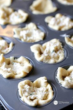 an uncooked muffin tin filled with mini pies