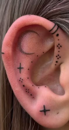 an ear with black crosses and stars on it