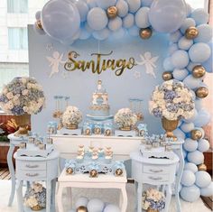 a blue and white dessert table with balloons