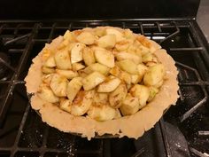 an uncooked pie sitting on top of the stove