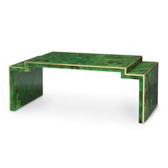 a green table sitting on top of a white floor next to a black and gold object