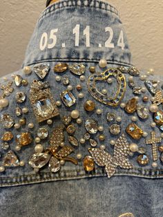 the back of a jean jacket with lots of jewels on it