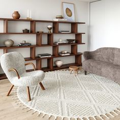 a living room filled with furniture and a white rug