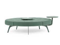 the circular coffee table has two tables on each side, and is made from green fabric