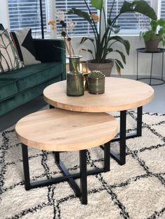 two tables sitting on top of a rug in a living room