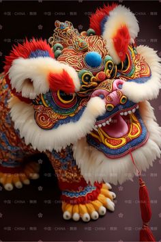 a close up of a dragon head with red and yellow decorations on it's face