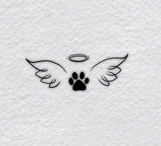 a dog's paw and angel wings with an angel halo above it on a white wall