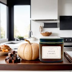 a candle sitting on top of a cutting board next to a bowl of fruit and nuts