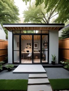 a small backyard office with sliding glass doors