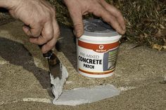 a man is spreading concrete with a knife