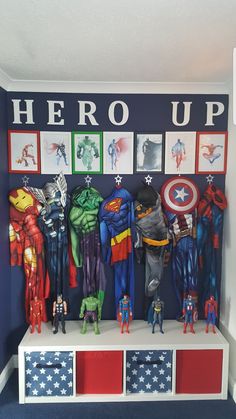 there are many superheros on the shelf in this boys's room, including captain america and iron man